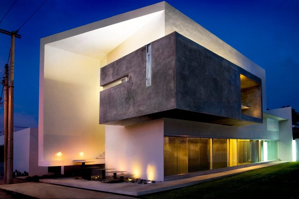 A modern house lit up at night in the evening
