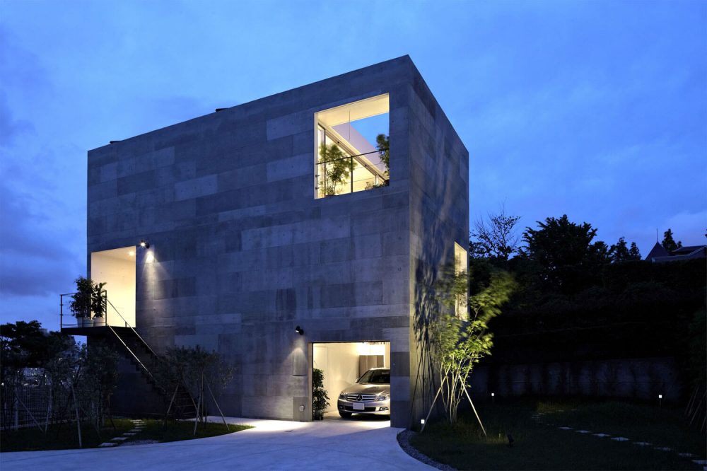 A car is parked in the driveway of a house
