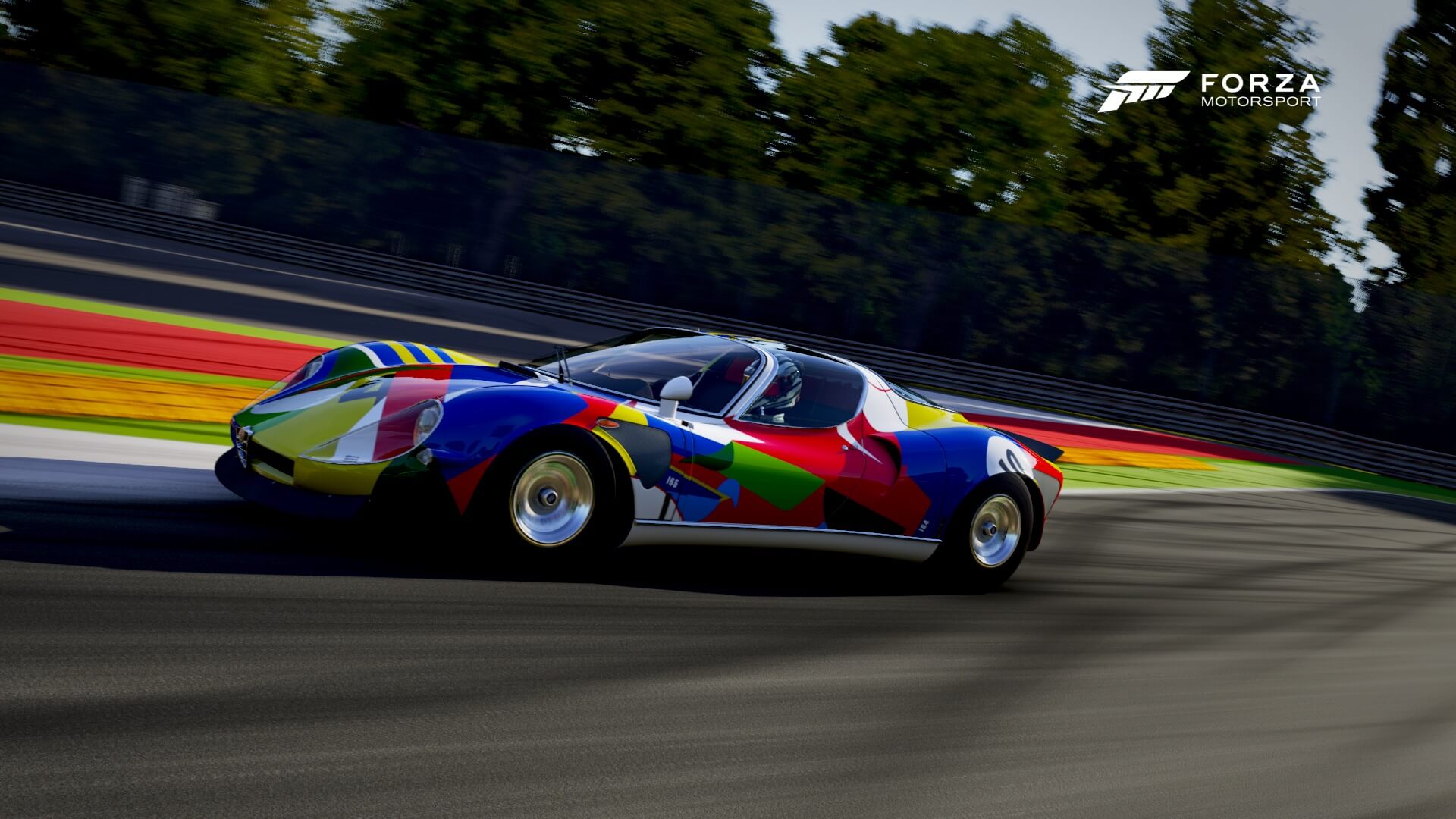 A colorful car driving down a race track
