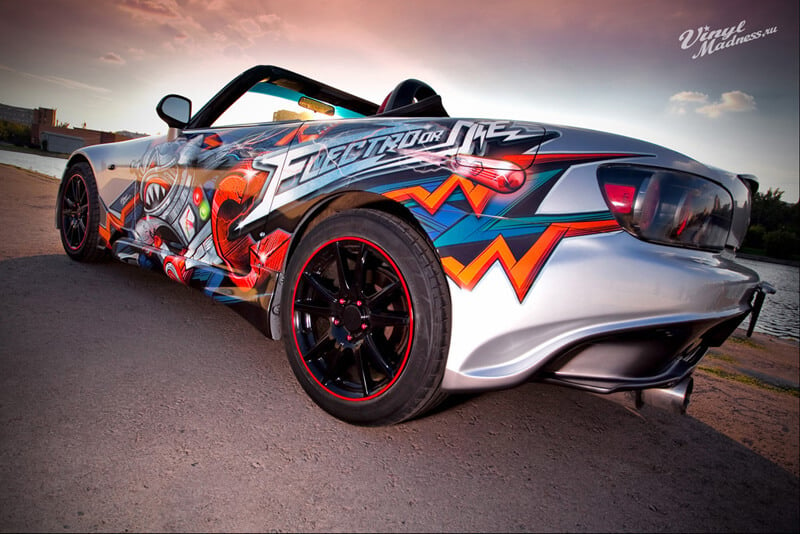 A silver sports car with a colorful paint job
