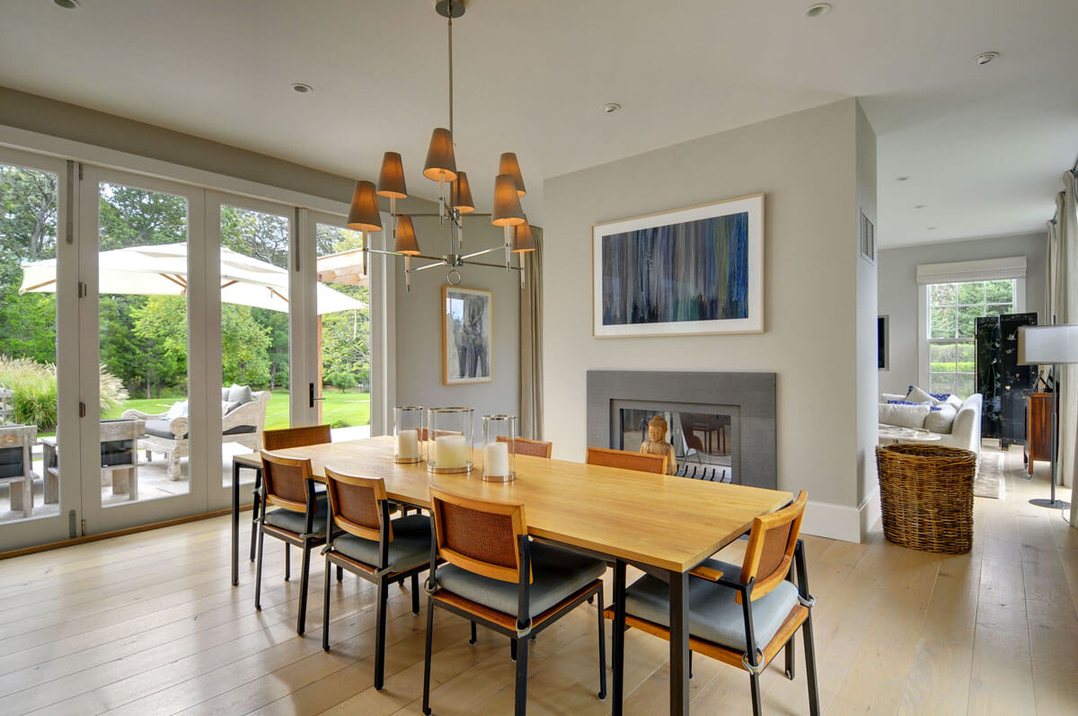 A dining room table with chairs and a fire place
