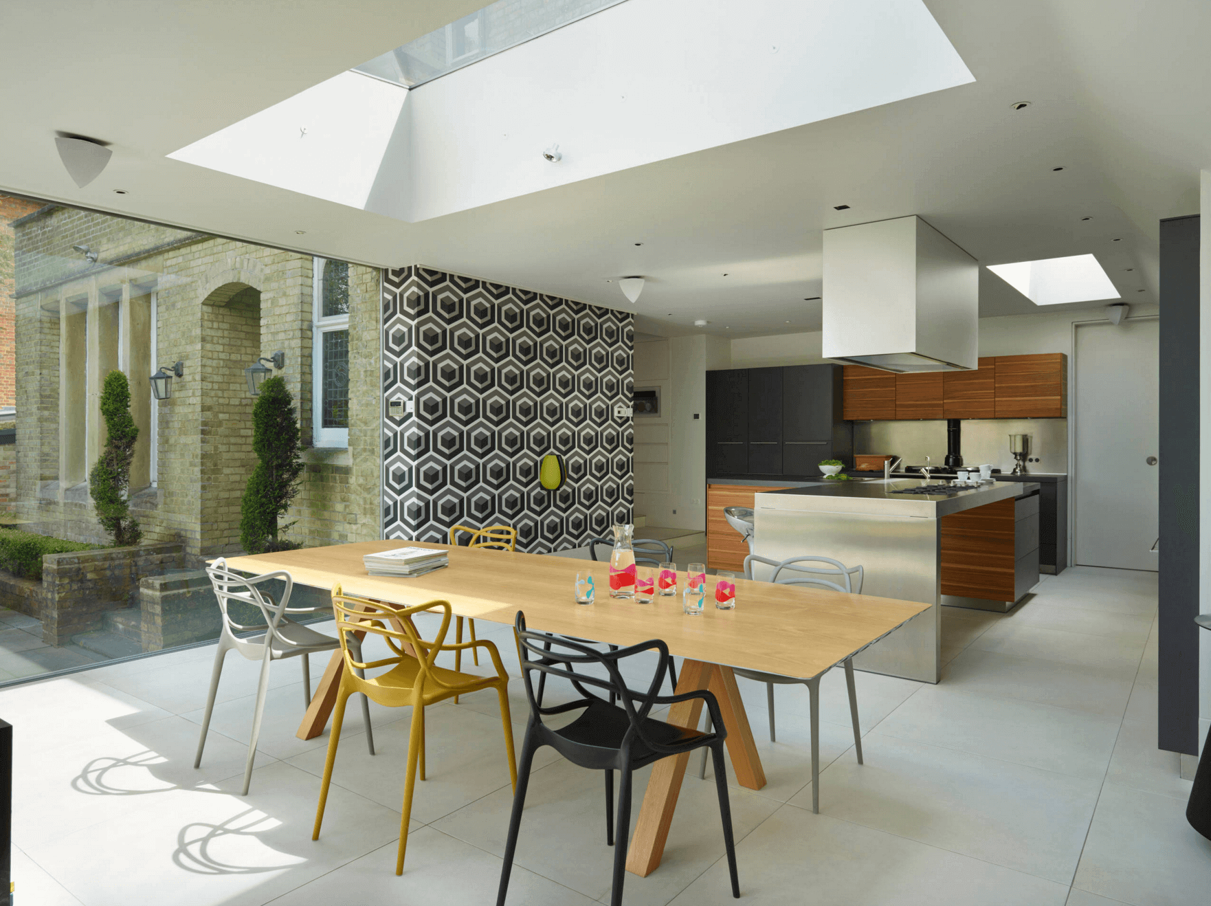 A kitchen with a table and chairs and a skylight
