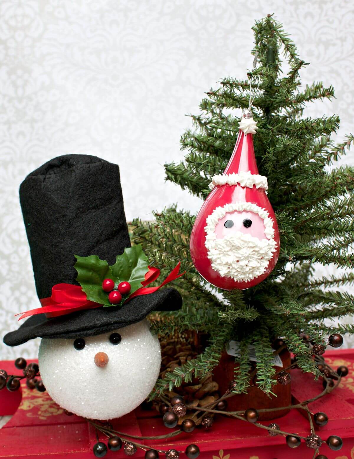 A christmas decoration with a snowman and a christmas tree
