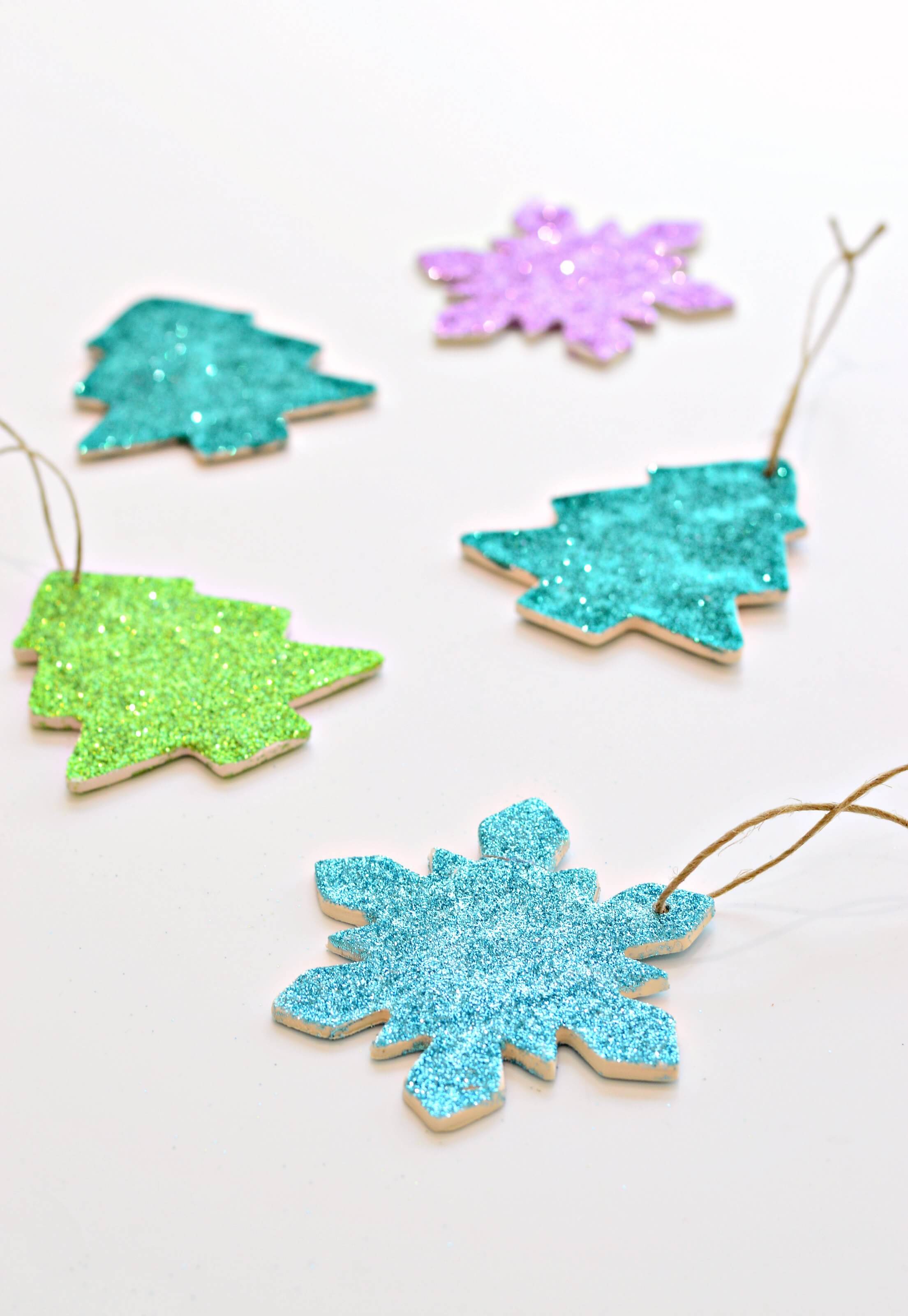 Glitter snowflake ornaments on a white table
