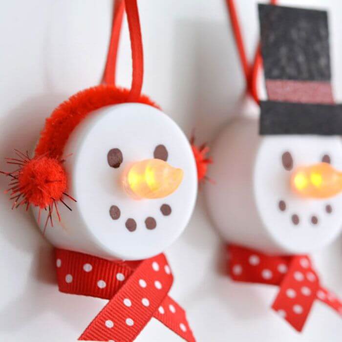 A couple of snowmen hanging from a wall

