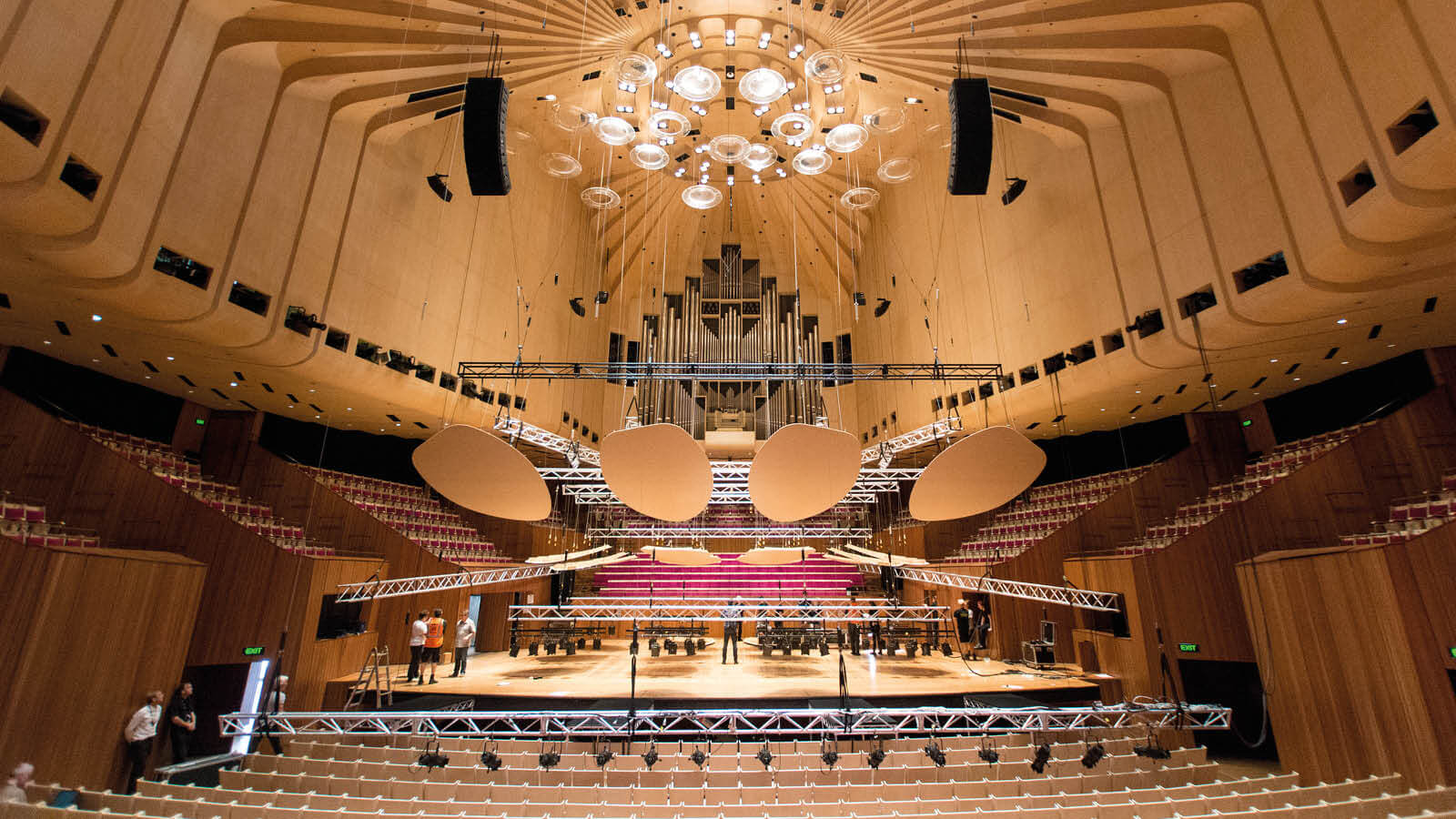 A concert hall with a chandelier hanging from the ceiling
