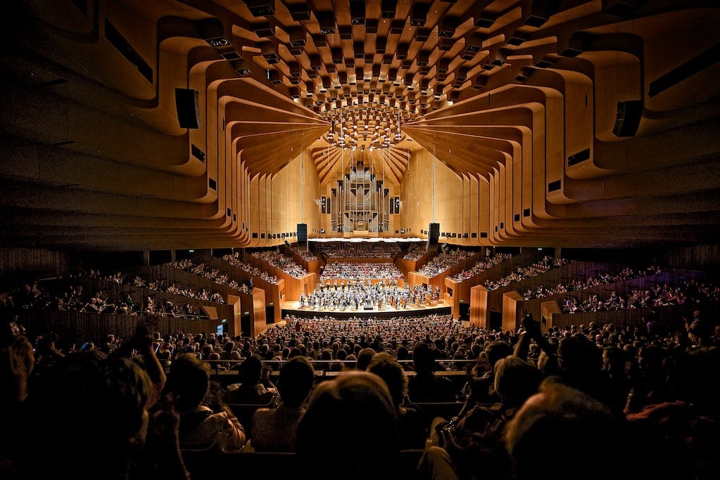 A concert hall filled with lots of people
