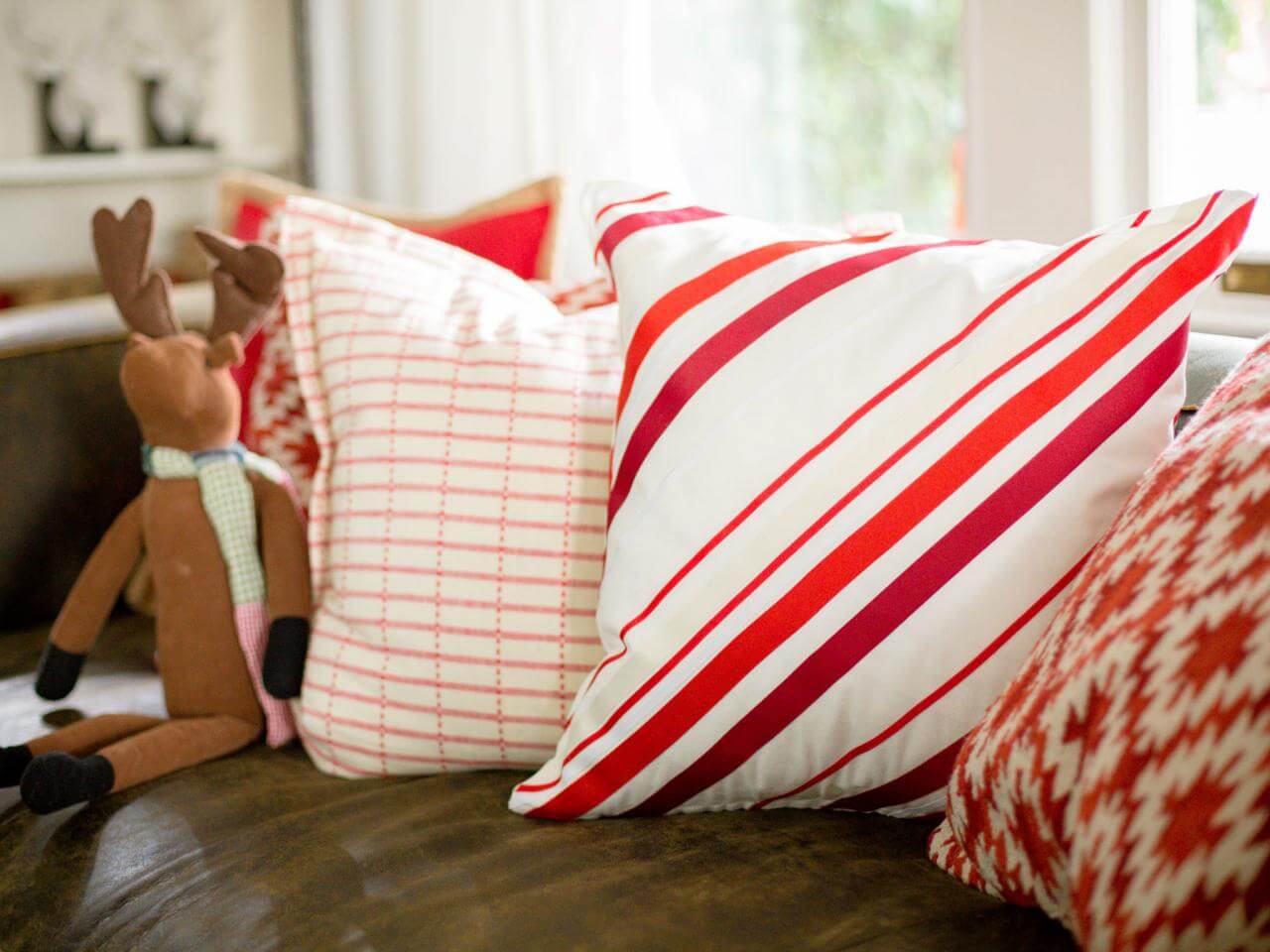 A close up of a couch with pillows on it
