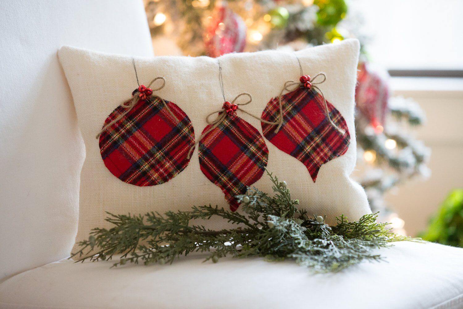 A plaid christmas ornament on a pillow on a chair
