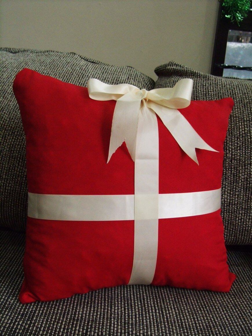 A red pillow with a white ribbon tied around it
