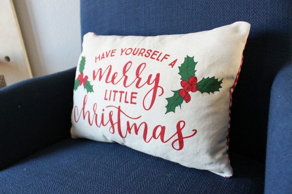 A pillow that says have yourself a merry little christmas
