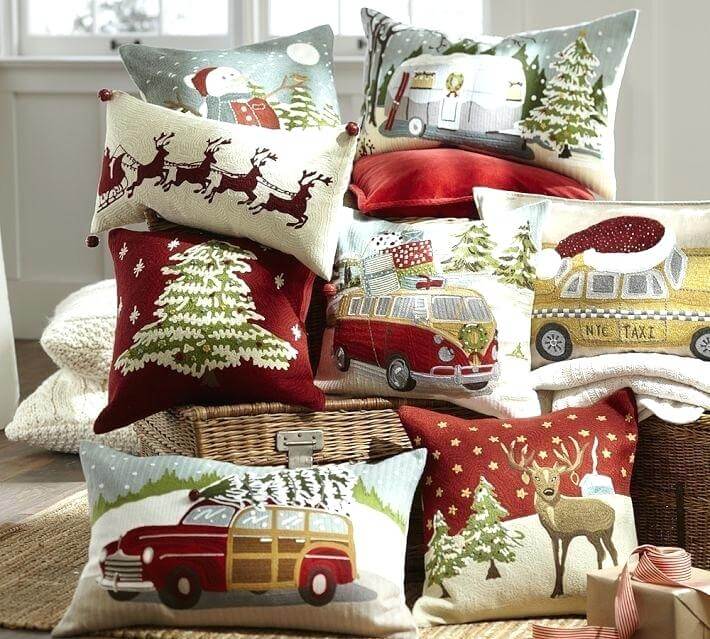 A pile of pillows with christmas decorations on them
