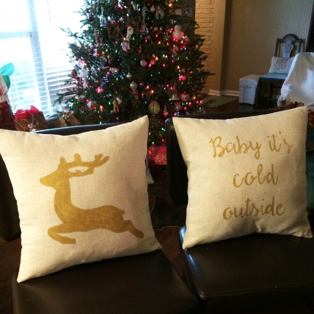 A couple of pillows sitting next to a christmas tree

