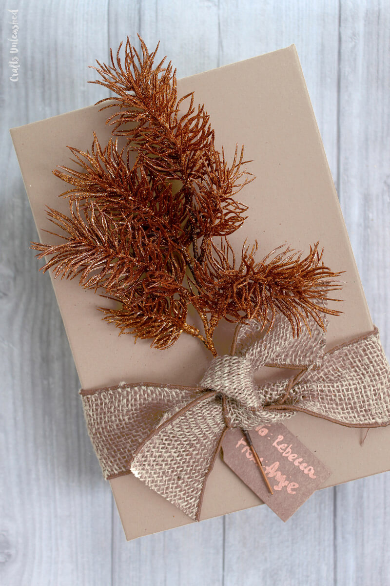 A gift wrapped in brown paper with a bow
