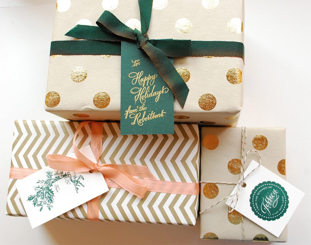 A stack of wrapped presents with a green ribbon
