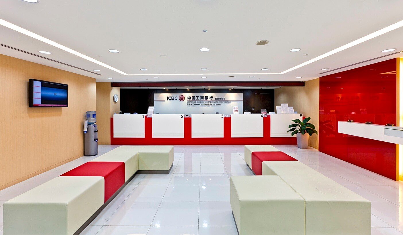 A white and red lobby with a television on the wall
