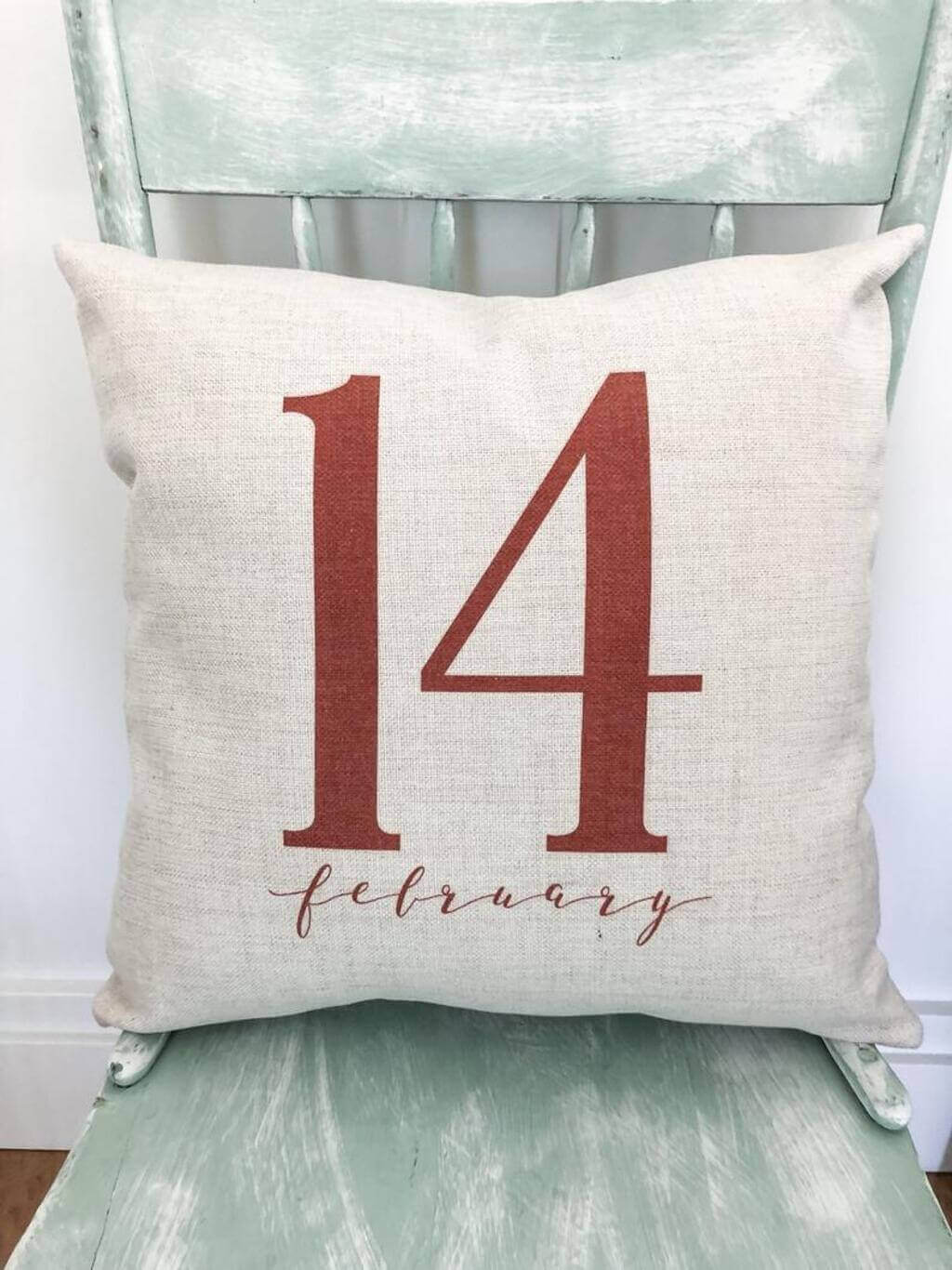 A chair with a pillow that says 14 february
