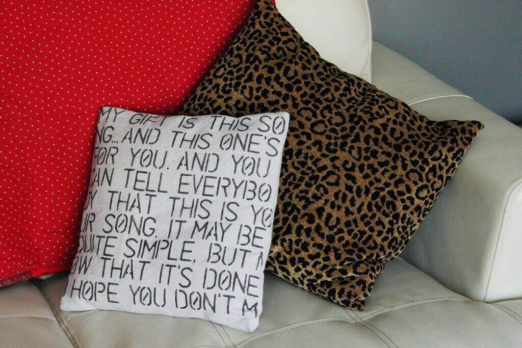 A couple of pillows sitting on top of a white couch
