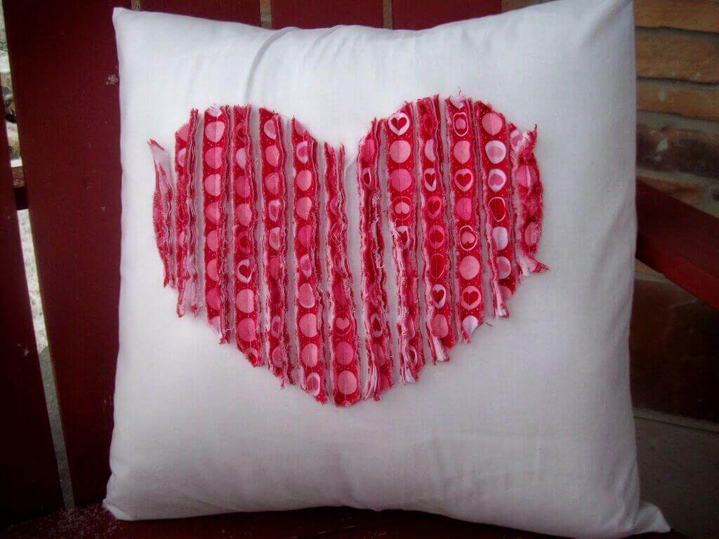 A pillow with a heart on it on a chair
