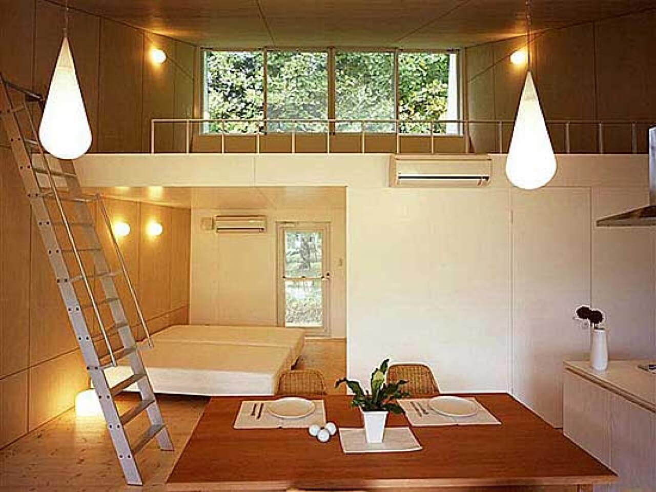 A room with a ladder and a bed in it
