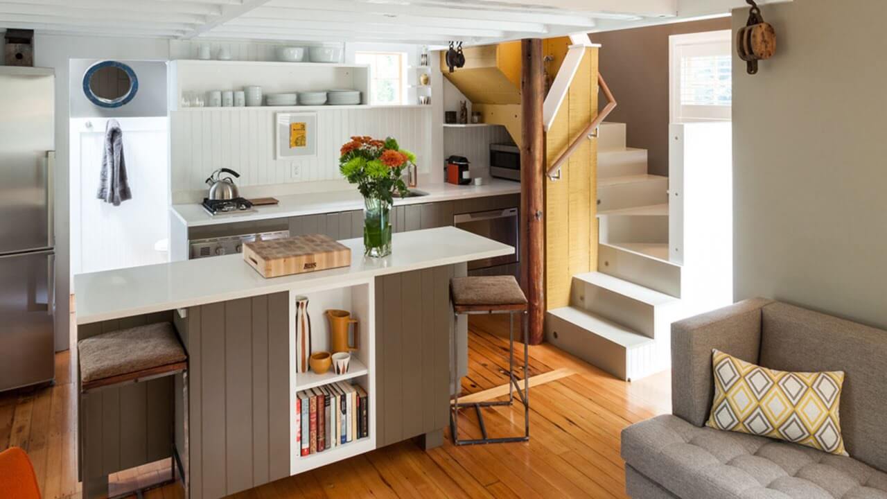 A kitchen with a couch and a table in it
