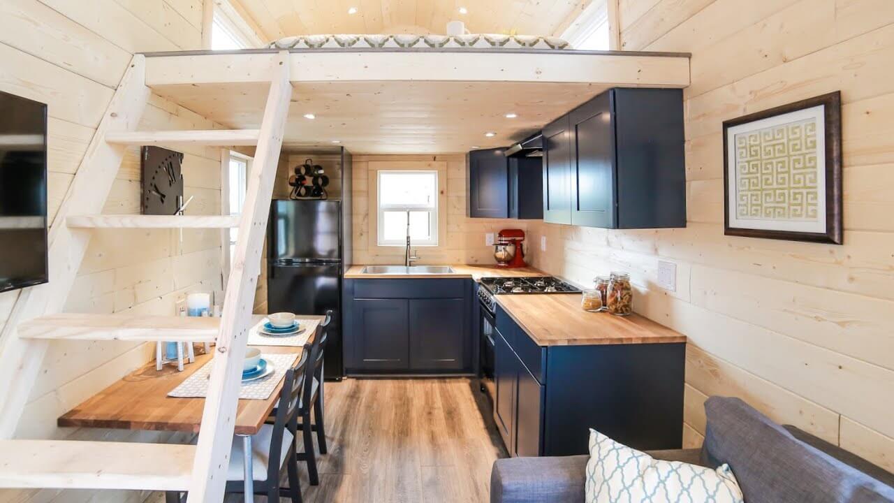 A kitchen and living room inside of a tiny house
