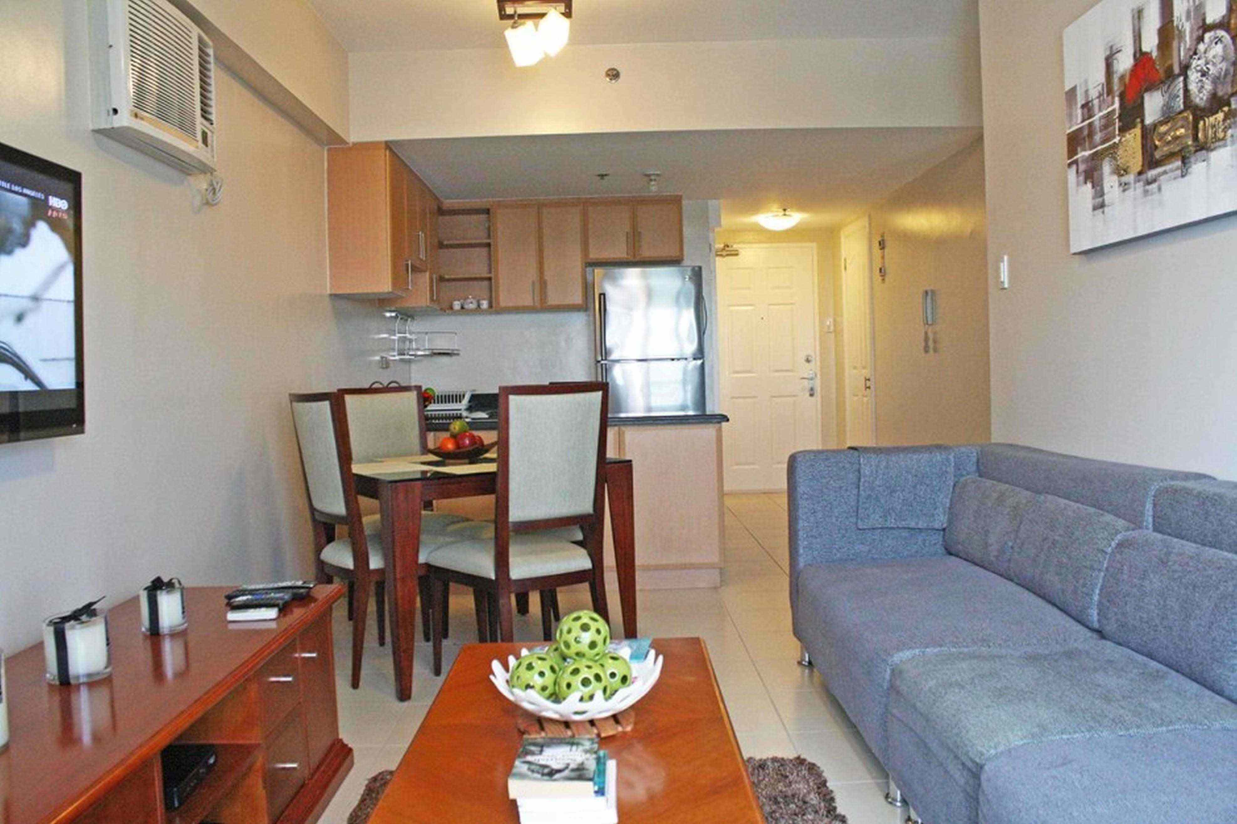 A living room filled with furniture and a flat screen tv
