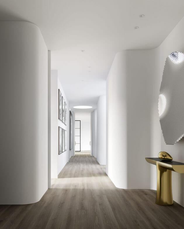 A long hallway with white walls and wooden floors
