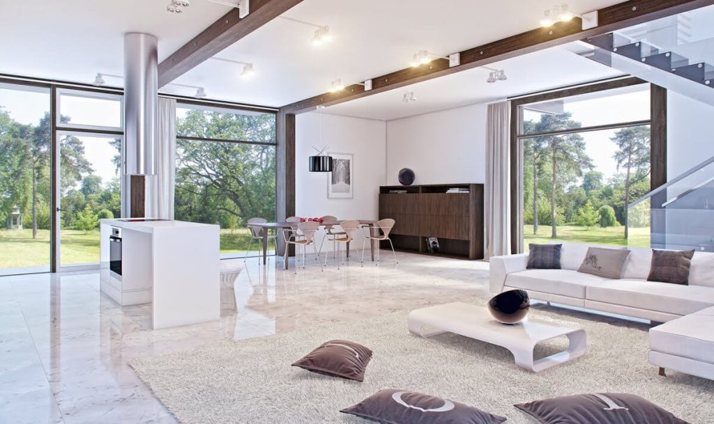 A living room filled with furniture and large windows
