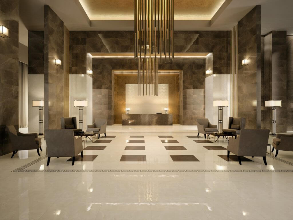 A lobby with a checkered floor and chandelier
