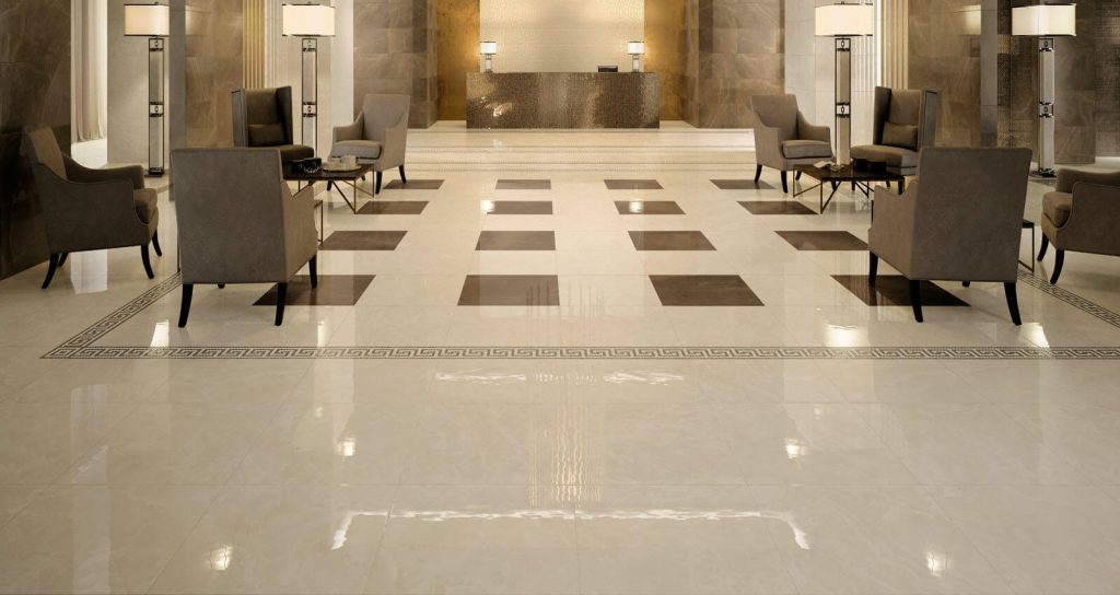 A hotel lobby with a checkered floor and chandelier
