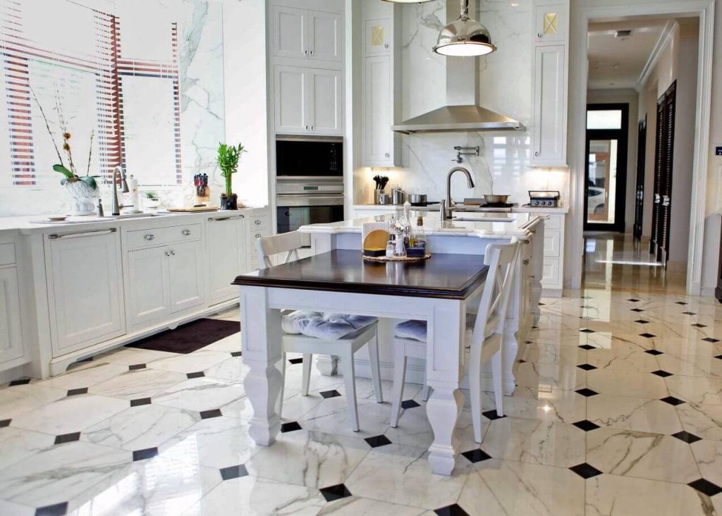 A kitchen with a marble floor and white cabinets
