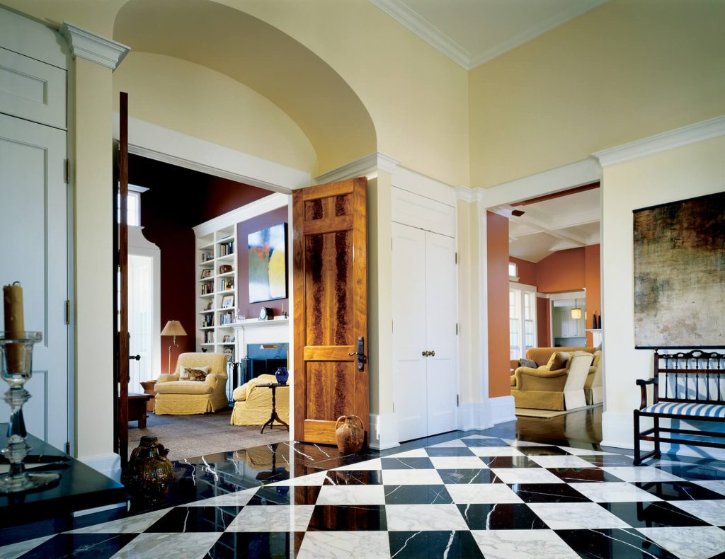 A living room with a black and white checkered floor
