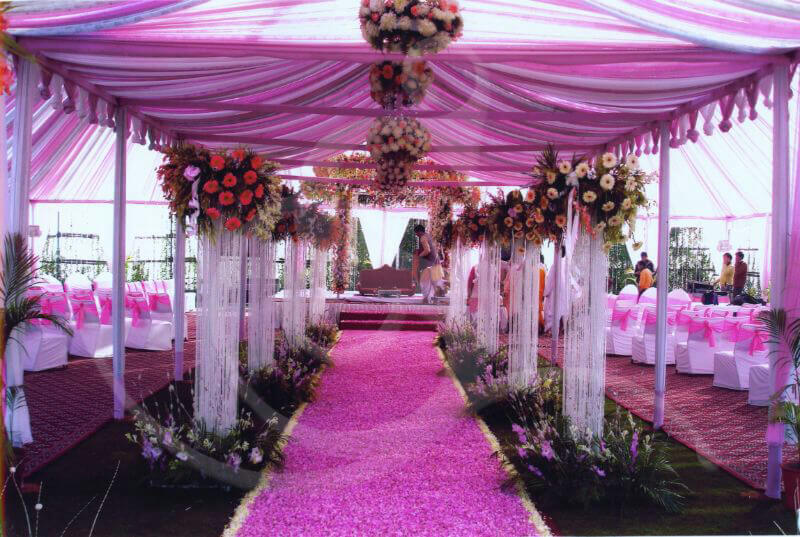 A pink and white wedding decorated with flowers

