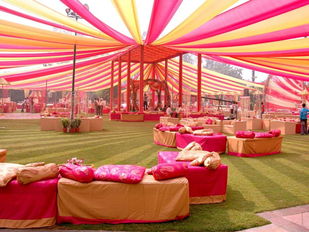 A large open area with lots of pink and yellow tents
