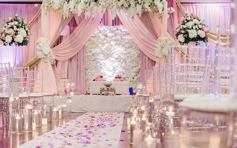A wedding ceremony setup with white and pink flowers
