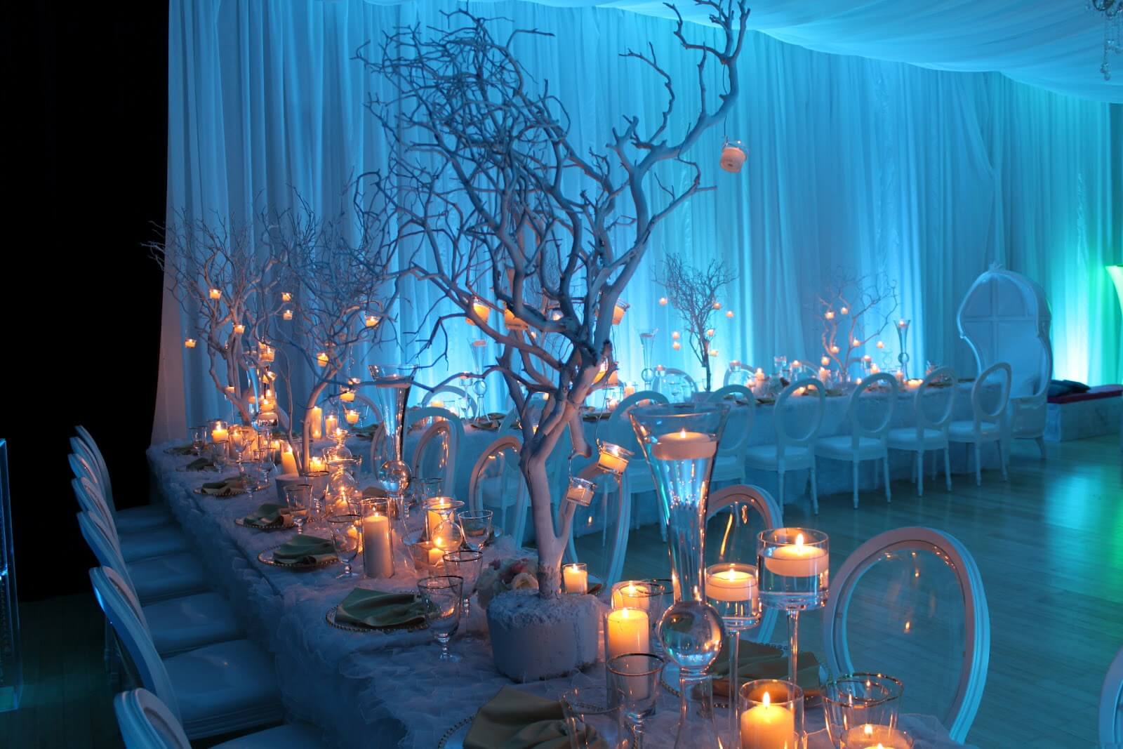 A long table with a bunch of candles on it
