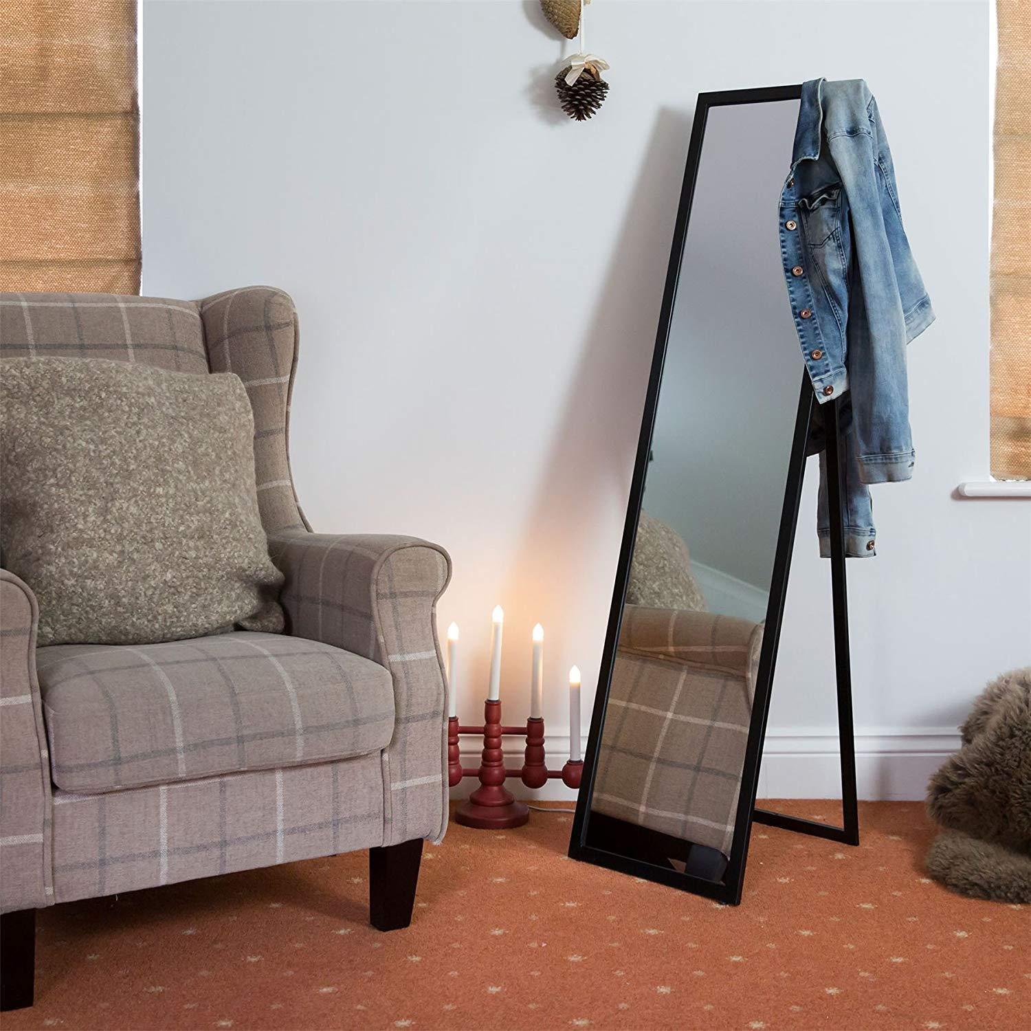 A room with a chair and a large mirror
