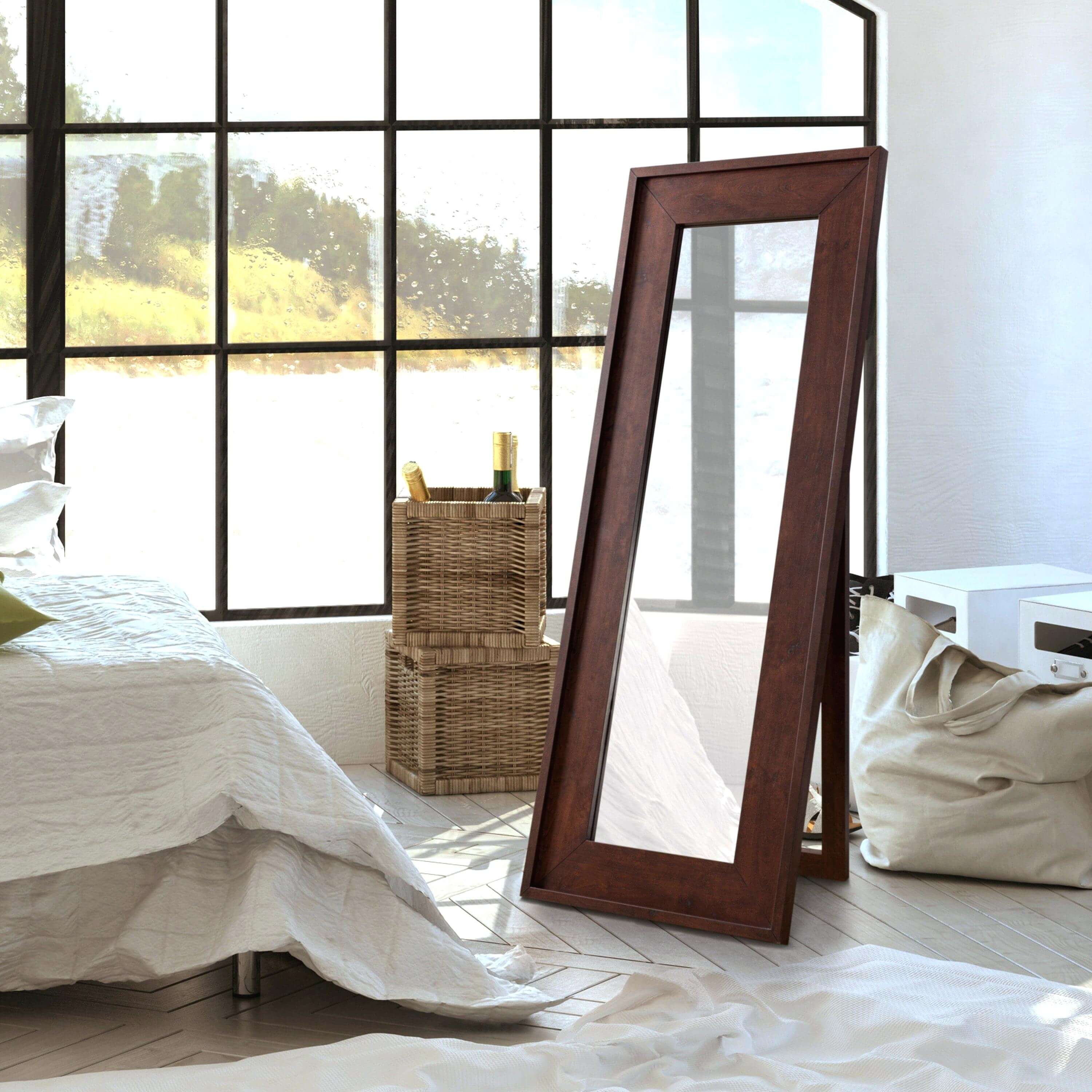 A large mirror sitting on top of a bed next to a window
