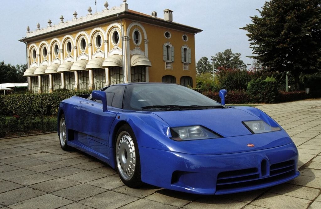 A blue Bugatti Centodieci car parked in front of a building
