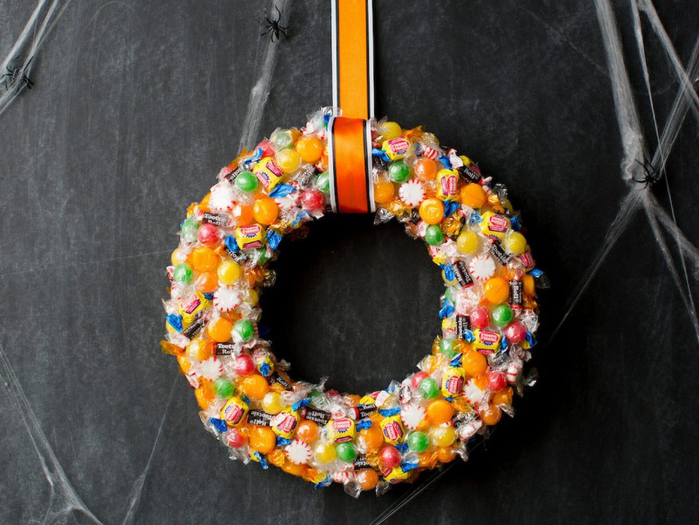 A candy wreath hanging on a wall
