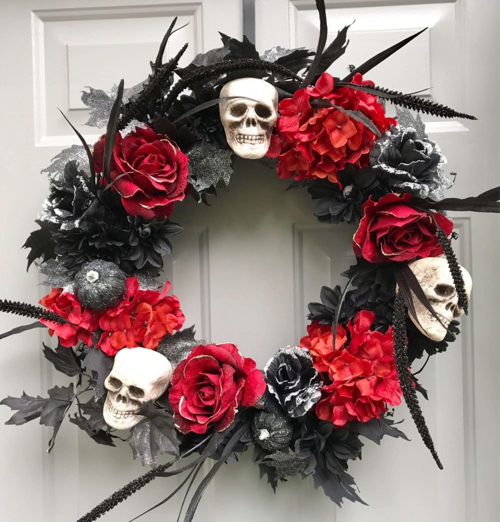A wreath with skulls and flowers on a door

