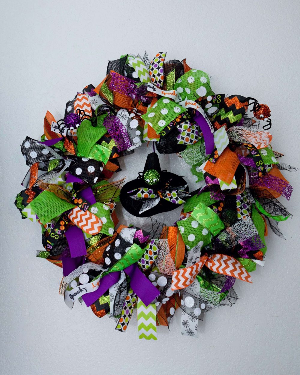 A halloween wreath with a cat on it

