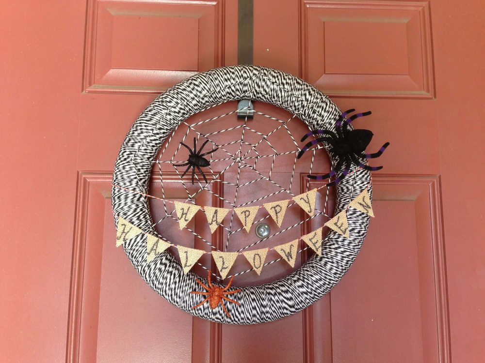 A halloween wreath hanging on a door
