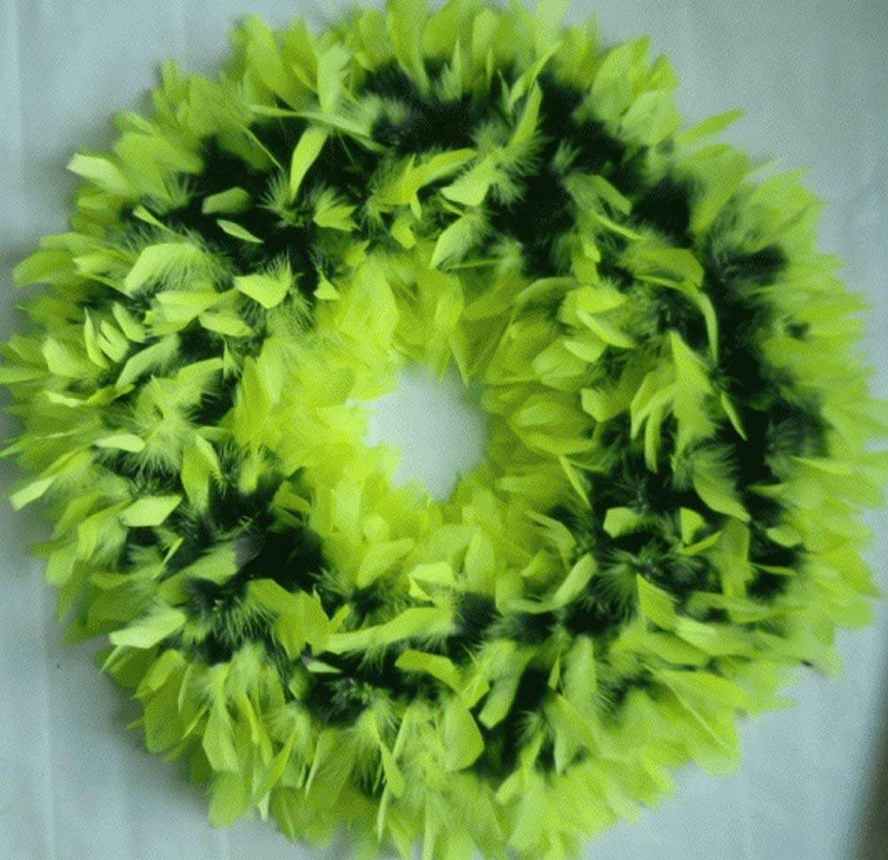 A green and black wreath on a white table
