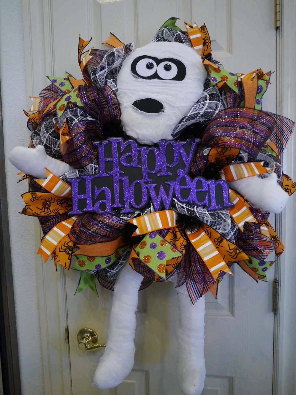 A halloween wreath with the words happy halloween on it
