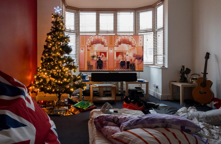 A living room with a christmas tree in the corner
