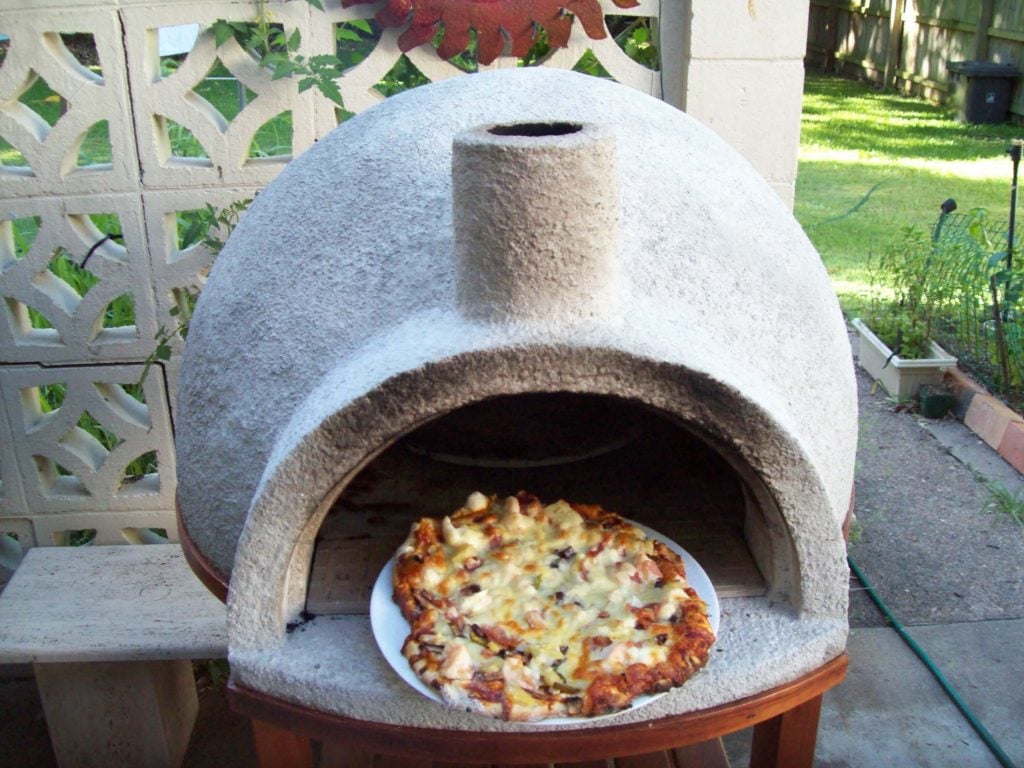 A pizza that is sitting in a stone oven
