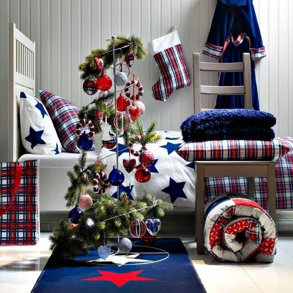 A christmas tree in a room decorated with red, white and blue decorations
