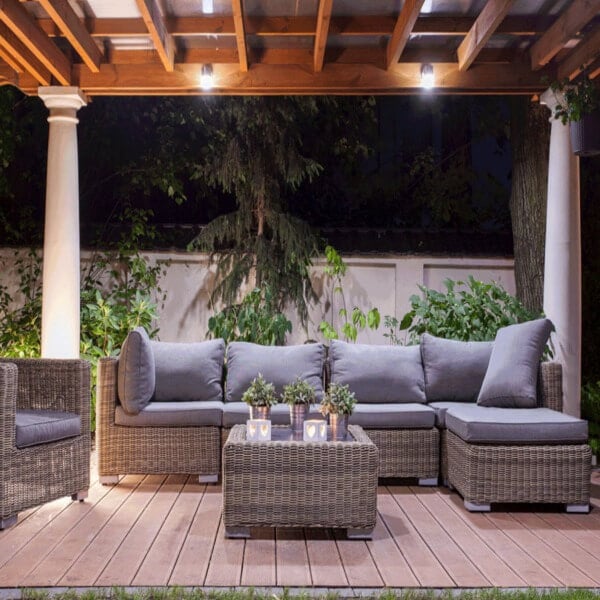 A patio with a couch, table and chairs
